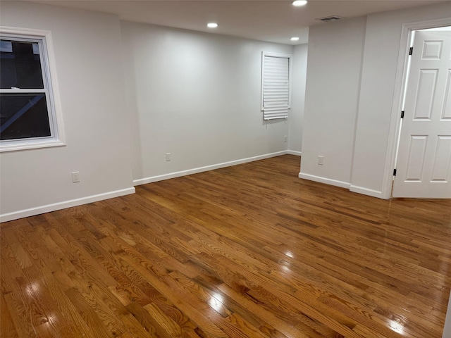 interior space with visible vents, baseboards, wood finished floors, and recessed lighting