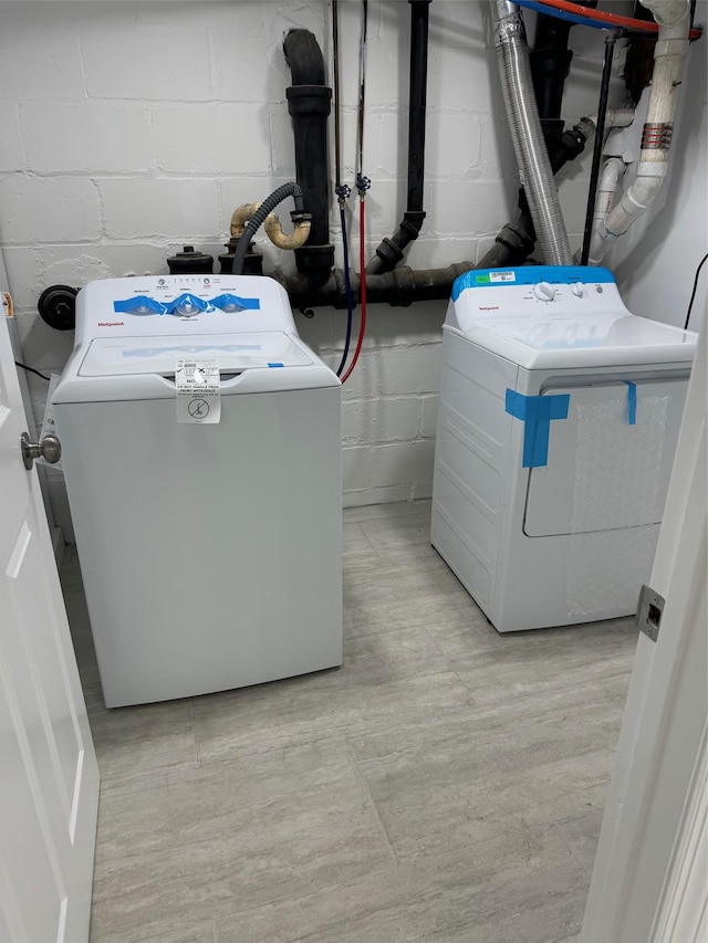 clothes washing area featuring laundry area and washer and clothes dryer