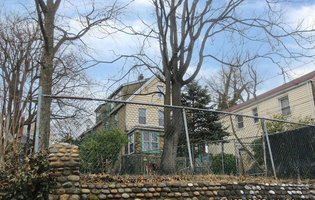 view of property exterior with fence and a chimney