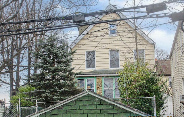 view of side of home featuring fence