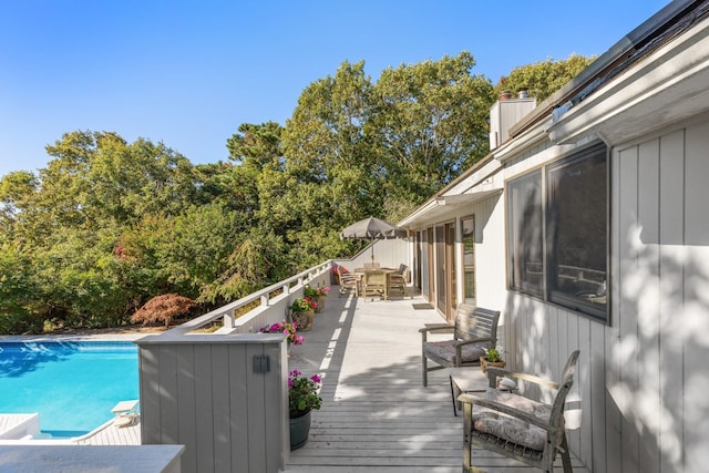 29 Kenwood Rd, Southampton, NY 11968 - deck with outdoor dining space and an outdoor pool