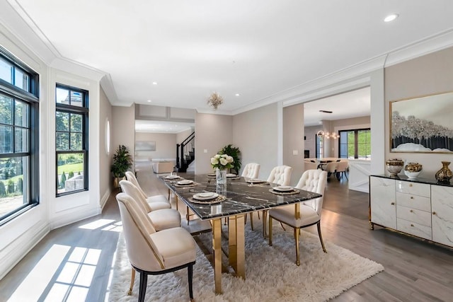 dining area featuring recessed lighting, crown molding, wood finished floors, stairs, and an inviting chandelier