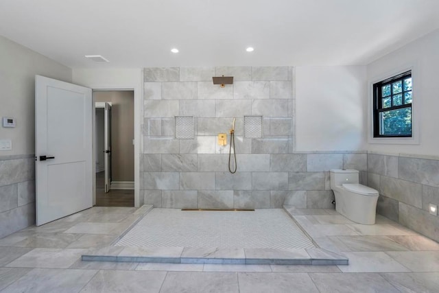 bathroom featuring toilet, walk in shower, tile walls, and recessed lighting