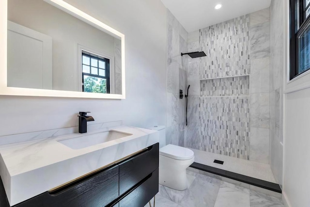 bathroom with marble finish floor, recessed lighting, toilet, vanity, and walk in shower