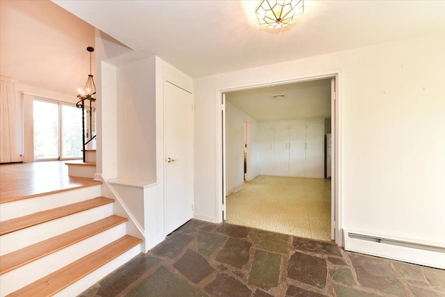 hall with visible vents, stairway, baseboard heating, tile patterned floors, and an inviting chandelier