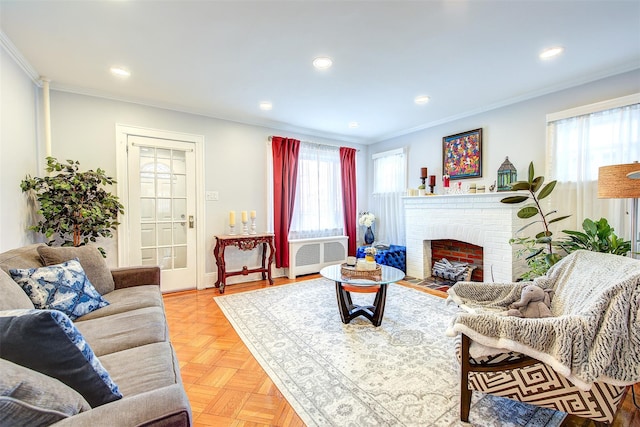 living area featuring a healthy amount of sunlight, a fireplace, crown molding, and recessed lighting