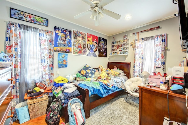 bedroom featuring a ceiling fan and crown molding