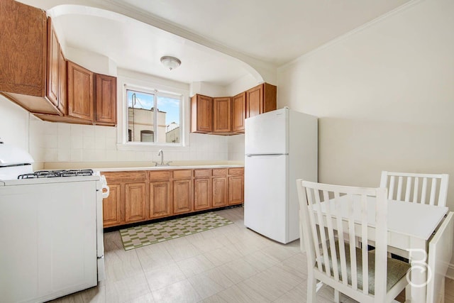 kitchen featuring light countertops, white appliances, brown cabinetry, and backsplash