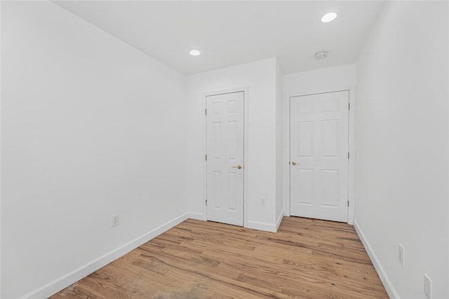 unfurnished bedroom with light wood finished floors, recessed lighting, and baseboards