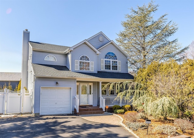 view of front of home with a porch, fence, driveway, roof with shingles, and a chimney