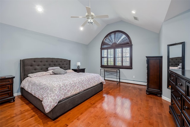 bedroom with visible vents, baseboards, lofted ceiling, hardwood / wood-style flooring, and a baseboard radiator