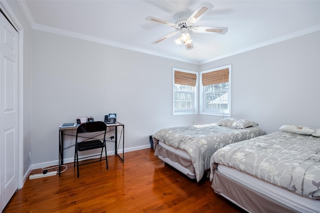 bedroom featuring dark wood-style flooring, crown molding, a closet, a ceiling fan, and baseboards