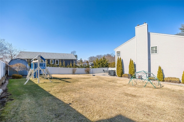 view of yard with a fenced backyard and a playground