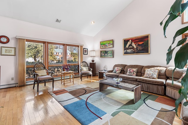 living area with light wood-style floors, visible vents, and high vaulted ceiling