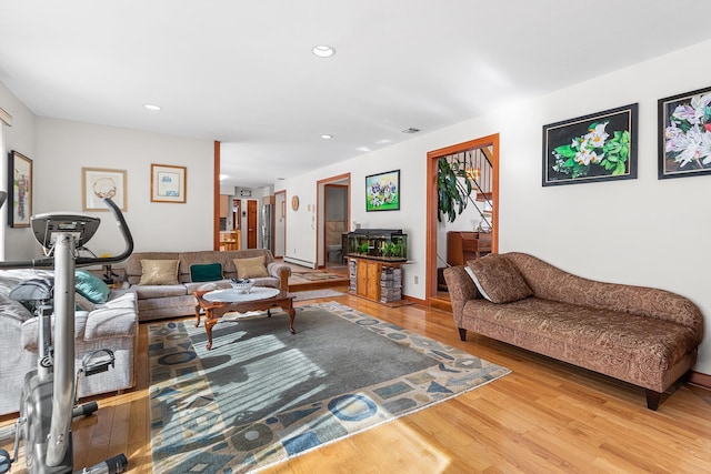 living area with recessed lighting and wood finished floors