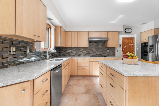 kitchen featuring black appliances, visible vents, under cabinet range hood, light brown cabinets, and a sink