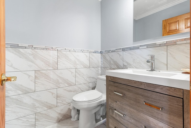 half bath featuring ornamental molding, tile walls, vanity, and toilet