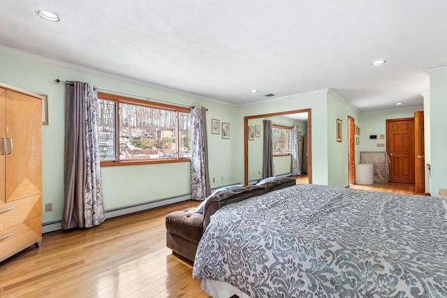 bedroom featuring a baseboard radiator, crown molding, and wood finished floors