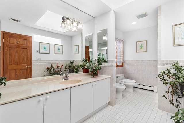 bathroom with a skylight, tile walls, baseboard heating, a bidet, and tile patterned flooring