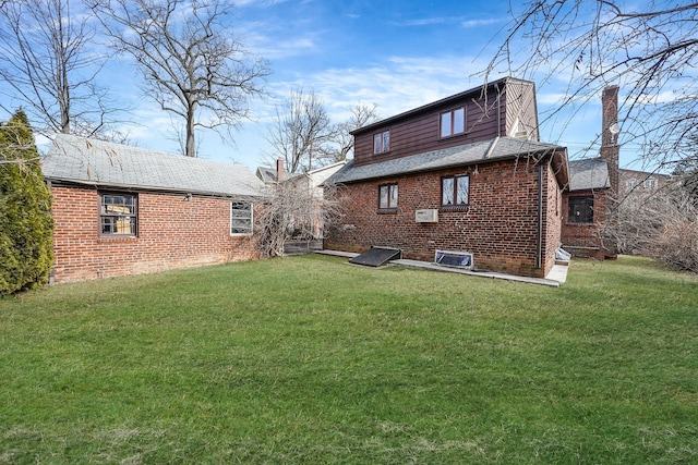182-37 Radnor Rd, Jamaica Estates, NY 11432 - rear view of property with a yard and brick siding