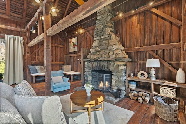 unfurnished living room with wood-type flooring, wooden walls, and a fireplace