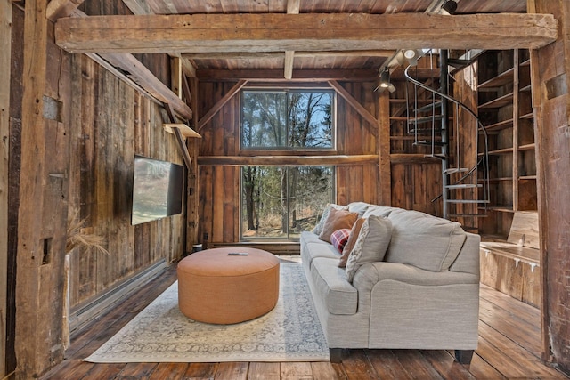 living area featuring hardwood / wood-style floors, wooden walls, wood ceiling, beamed ceiling, and baseboard heating