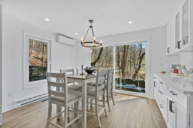 dining room with a wall mounted AC, recessed lighting, a notable chandelier, light wood-type flooring, and baseboard heating