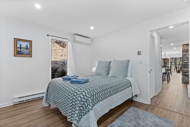 bedroom with baseboards, recessed lighting, wood finished floors, a wall mounted AC, and a baseboard radiator