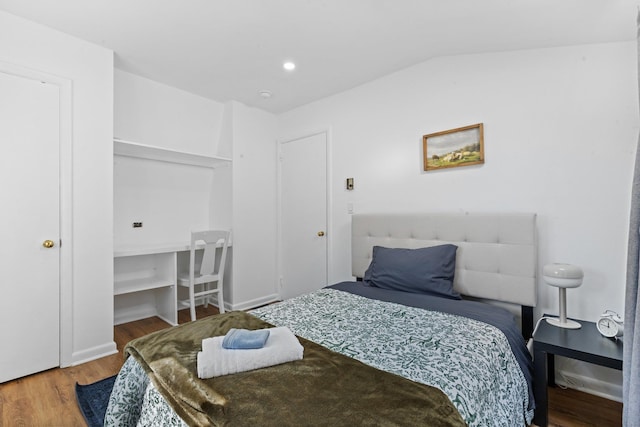 bedroom featuring lofted ceiling, recessed lighting, and wood finished floors