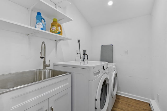 laundry room with baseboards, dark wood finished floors, separate washer and dryer, cabinet space, and a sink