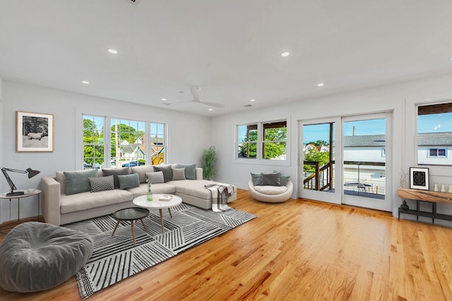 living area with recessed lighting, baseboards, and wood finished floors