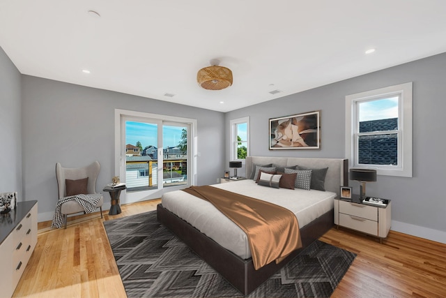 bedroom featuring recessed lighting, light wood-type flooring, visible vents, and baseboards