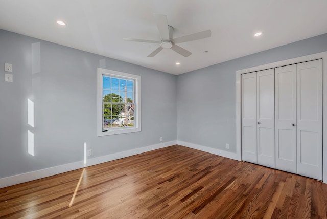 unfurnished bedroom featuring baseboards, a ceiling fan, wood finished floors, a closet, and recessed lighting