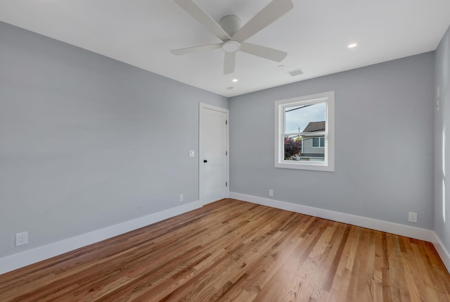 spare room with a ceiling fan, recessed lighting, light wood-style flooring, and baseboards