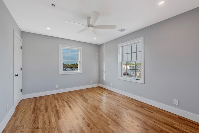 unfurnished room with recessed lighting, a ceiling fan, light wood-style floors, visible vents, and baseboards