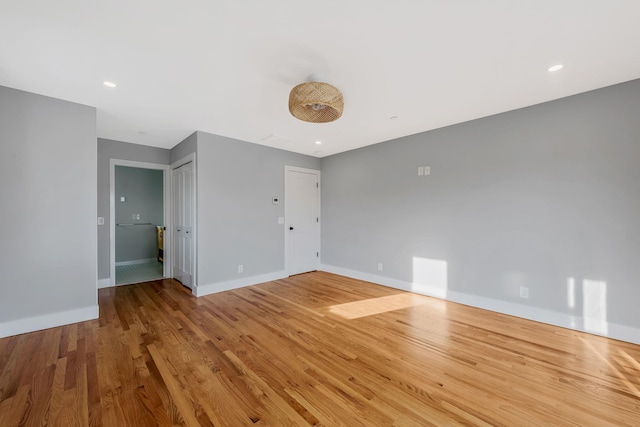 interior space featuring recessed lighting, light wood-style flooring, and baseboards