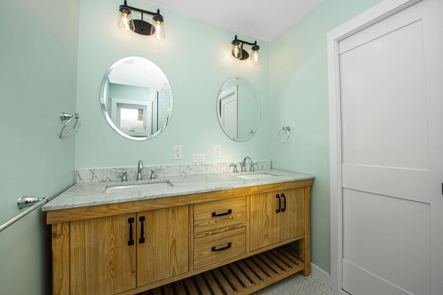 bathroom featuring a sink, baseboards, and double vanity