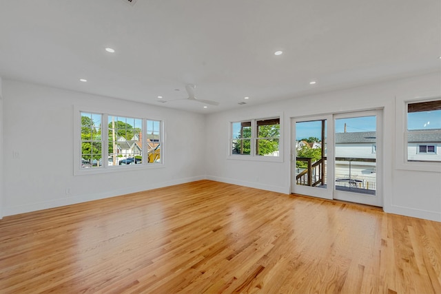 spare room featuring recessed lighting, baseboards, and light wood finished floors