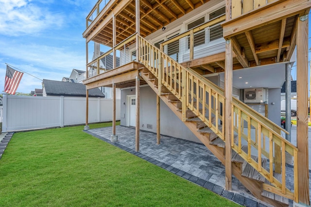 exterior space featuring a patio area, stairs, fence, and a yard