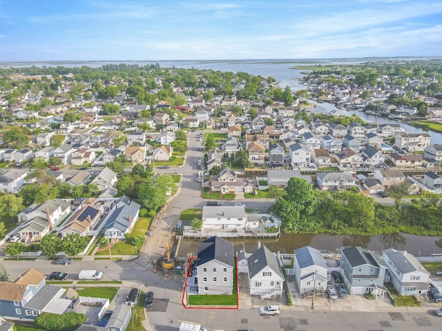 bird's eye view featuring a water view and a residential view