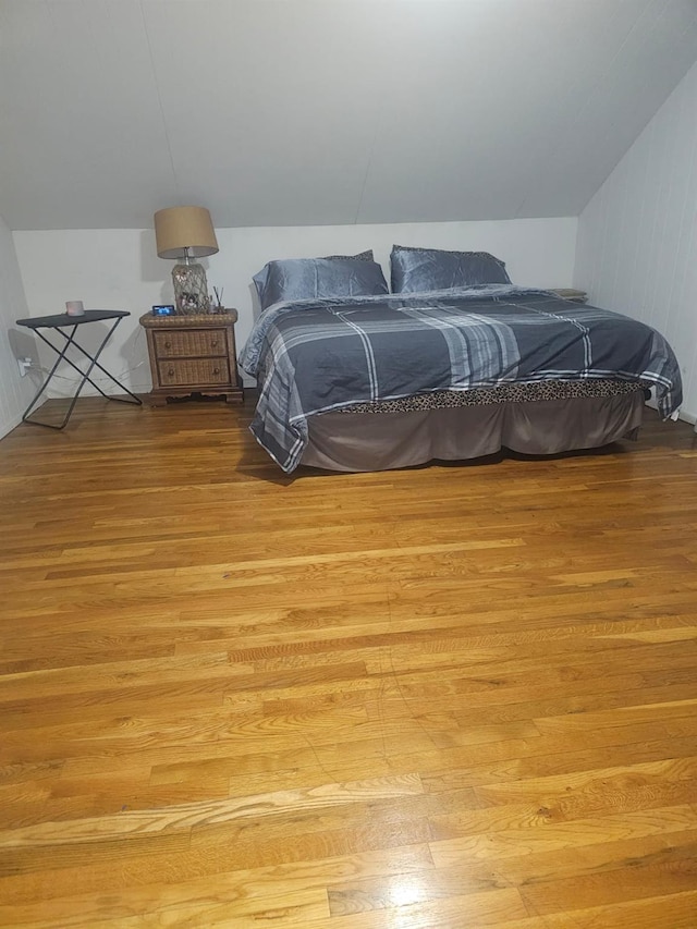 bedroom featuring vaulted ceiling and light wood-style flooring