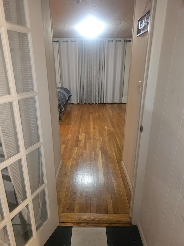 hallway with wood-type flooring