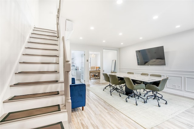 interior space featuring wainscoting, recessed lighting, wood finished floors, and a decorative wall