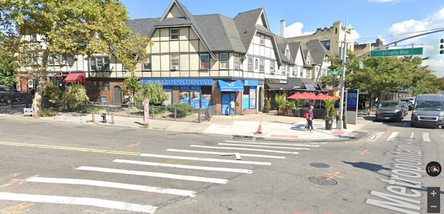 view of street featuring curbs, sidewalks, and traffic lights