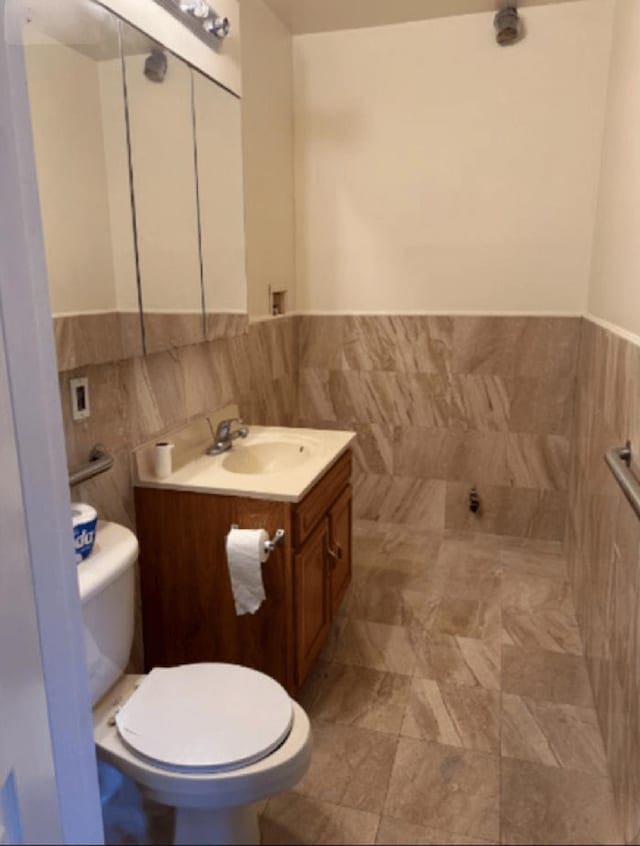 118-82 Metropolitan Ave Unit 1B, Kew Gardens, NY 11415 - bathroom with tile walls, toilet, vanity, and wainscoting