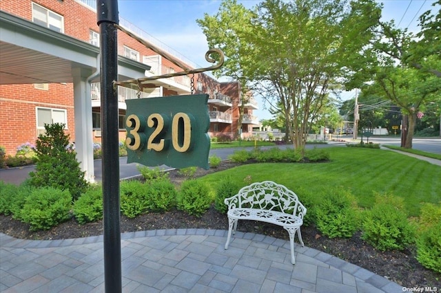 community / neighborhood sign with a yard