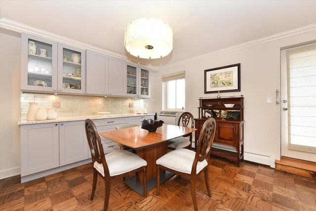 dining area with baseboard heating and crown molding