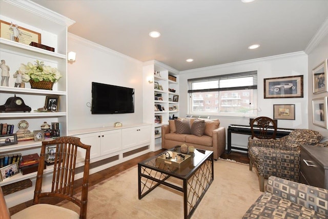 living room with recessed lighting, built in shelves, crown molding, and light wood finished floors