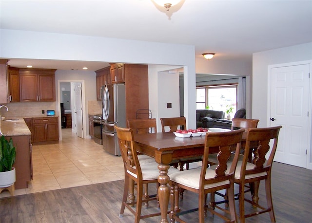 dining area with recessed lighting and light wood finished floors