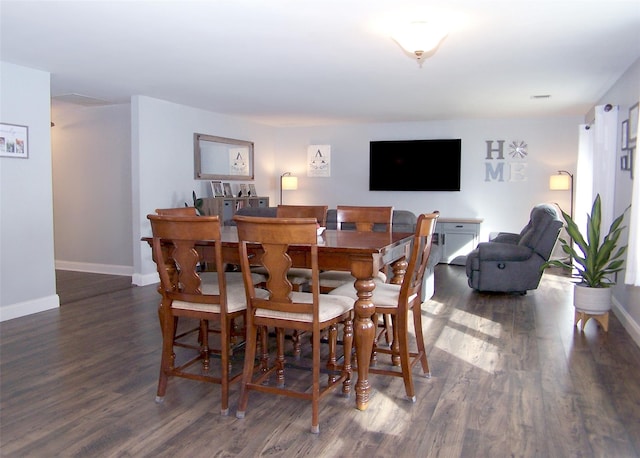 dining space with wood finished floors and baseboards